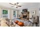 Comfortable living room with stone fireplace, ceiling fan, and plush seating, perfect for relaxation at 1768 San Andra Dr, Marietta, GA 30062