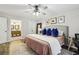 Comfortable main bedroom with ensuite bathroom access, ceiling fan and accent lighting at 1768 San Andra Dr, Marietta, GA 30062