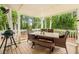 Covered patio with a dining table, bench and grill, surrounded by lush trees at 1768 San Andra Dr, Marietta, GA 30062