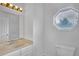 Bright bathroom featuring an octagon window, neutral tile, and shower with white fixtures at 4440 Coventry Ne Ct, Roswell, GA 30075