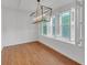 Bright dining area with stylish chandelier, white shutters, and wood-look floors at 4440 Coventry Ne Ct, Roswell, GA 30075