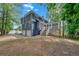 View of the home's exterior with ample parking and rear deck and porch at 4440 Coventry Ne Ct, Roswell, GA 30075