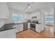 Modern kitchen with stainless steel appliances, white cabinets, and hardwood floors at 4440 Coventry Ne Ct, Roswell, GA 30075