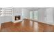 Cozy living room with hardwood floors, a fireplace, and access to an outdoor deck at 4440 Coventry Ne Ct, Roswell, GA 30075