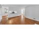 Spacious living room with hardwood floors and an open view to the kitchen area at 4440 Coventry Ne Ct, Roswell, GA 30075