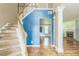 Inviting entryway with staircase and views into the living room with a cozy fireplace feature at 745 Birchberry Sw Ter, Atlanta, GA 30331