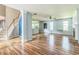 Open-concept living room with wood floors, fireplace, and lots of natural light from the large windows at 745 Birchberry Sw Ter, Atlanta, GA 30331