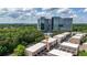 Aerial view showcasing stylish townhouses near an office building, surrounded by lush greenery and mature trees at 1626 Aldworth Se Pl, Atlanta, GA 30339