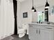 Bright bathroom with a walk-in shower, sleek vanity with pendant lights, and modern fixtures at 1626 Aldworth Se Pl, Atlanta, GA 30339