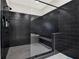 Shower featuring black subway tile, frameless glass, and bench seating at 1626 Aldworth Se Pl, Atlanta, GA 30339