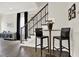 Stylish entryway with staircase, dark wood floors, and a small seating area with barstools at 1626 Aldworth Se Pl, Atlanta, GA 30339