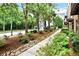 Landscaped front yard with a sidewalk, stones, bushes, trees, and well-manicured greenery at 1626 Aldworth Se Pl, Atlanta, GA 30339