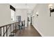 Second floor hallway with hardwood floors and modern light fixtures at 1626 Aldworth Se Pl, Atlanta, GA 30339