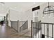 Bright hallway features dark wood floors, decorative lighting, and modern railings at 1626 Aldworth Se Pl, Atlanta, GA 30339