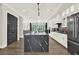 Modern kitchen featuring white cabinets, black marble countertops, a large island, and stainless steel appliances for a sleek design at 1626 Aldworth Se Pl, Atlanta, GA 30339