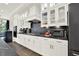 This modern kitchen showcases white cabinets, marble countertops and backsplash, and professional grade appliances for the home chef at 1626 Aldworth Se Pl, Atlanta, GA 30339