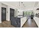 A spacious kitchen with a large black marble island, modern appliances, and hardwood flooring, perfect for cooking and entertaining at 1626 Aldworth Se Pl, Atlanta, GA 30339