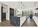 A spacious kitchen with a large black marble island, modern appliances, and hardwood flooring, perfect for cooking and entertaining at 1626 Aldworth Se Pl, Atlanta, GA 30339