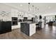 Modern kitchen featuring white cabinets, black marble countertops, a large island, and stainless steel appliances for a sleek design at 1626 Aldworth Se Pl, Atlanta, GA 30339
