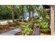 Beautifully landscaped front yard featuring vibrant pink flowers, lush greenery, and charming stone accents at 1626 Aldworth Se Pl, Atlanta, GA 30339