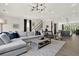 Elegant living room featuring a modern light fixture and an open floor plan to the kitchen at 1626 Aldworth Se Pl, Atlanta, GA 30339