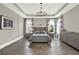 Serene main bedroom with tray ceiling, modern chandelier, and neutral decor at 1626 Aldworth Se Pl, Atlanta, GA 30339