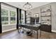 Spacious office features a large window, a glass desk, and built-in shelving at 1626 Aldworth Se Pl, Atlanta, GA 30339