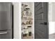 Pantry features multiple shelves filled with kitchenware and food, next to a gray door at 1626 Aldworth Se Pl, Atlanta, GA 30339