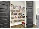 Walk-in pantry offers lots of shelving for storage, featuring wood floor and gray door at 1626 Aldworth Se Pl, Atlanta, GA 30339