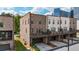 Rear exterior view of townhouses featuring a deck with garage parking and a well-manicured lawn at 1626 Aldworth Se Pl, Atlanta, GA 30339