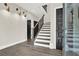 Bright foyer showcases a staircase with wood handrail, accompanied by dark doors and wood floor at 1626 Aldworth Se Pl, Atlanta, GA 30339