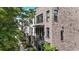 Street view of modern brick townhouses with balconies and landscaped sidewalks, blending urban living with nature at 1626 Aldworth Se Pl, Atlanta, GA 30339