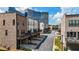 Street view of modern townhouses with balconies and attached garages in a well-maintained community at 1626 Aldworth Se Pl, Atlanta, GA 30339