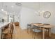 Bright dining area showcasing an oval wood table with seating for four and contemporary light fixture at 230 New St # 2102, Decatur, GA 30030