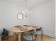 Contemporary dining room features a wood table with seating for four, wood floors, and modern lighting at 230 New St # 2102, Decatur, GA 30030