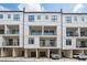 A modern townhome complex showcasing multi-level balconies, private garages, and uniform architectural design at 230 New St # 2102, Decatur, GA 30030
