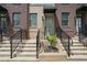 Brick townhome entrance with concrete steps, black railings, and a covered doorway at 230 New St # 2102, Decatur, GA 30030