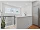 Hallway features hardwood floors, black railings, and plenty of natural light from the large window at 230 New St # 2102, Decatur, GA 30030