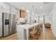 Kitchen featuring white countertops, stainless steel appliances, an island, and wood floors at 230 New St # 2102, Decatur, GA 30030