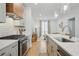 Kitchen with white countertops, a gas range, stainless steel appliances, and wood floors at 230 New St # 2102, Decatur, GA 30030