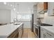 Modern kitchen featuring stainless steel appliances, white cabinetry, wood accents, and hardwood floors at 230 New St # 2102, Decatur, GA 30030