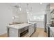 Kitchen with an island, white cabinets, stainless steel appliances, and hardwood floors at 230 New St # 2102, Decatur, GA 30030