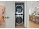 Efficient laundry closet featuring a stacked washer and dryer unit, optimizing space in the home at 230 New St # 2102, Decatur, GA 30030