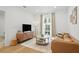 Bright living room with modern furniture, wood floors, and a large window at 230 New St # 2102, Decatur, GA 30030