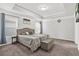 Comfortable carpeted bedroom with tray ceiling, upholstered headboard, and neutral color scheme at 3219 Colchester St, Douglasville, GA 30135