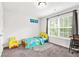 Bright bedroom with a whimsical Spongebob-themed decor and large window at 3219 Colchester St, Douglasville, GA 30135