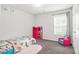 Cozy bedroom featuring playful unicorn-themed decor and soft gray carpet at 3219 Colchester St, Douglasville, GA 30135