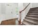 Inviting entryway featuring a staircase, hardwood floors, and stylish wainscoting at 3219 Colchester St, Douglasville, GA 30135