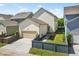 Two-story home with attached garage, concrete driveway, manicured lawn and wood fence at 3219 Colchester St, Douglasville, GA 30135