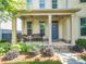 Charming front porch with seating area and beautifully landscaped front yard at 3219 Colchester St, Douglasville, GA 30135